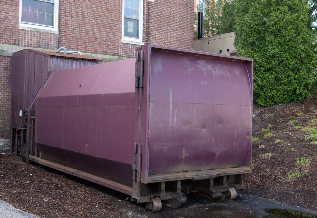Red large compactor outside