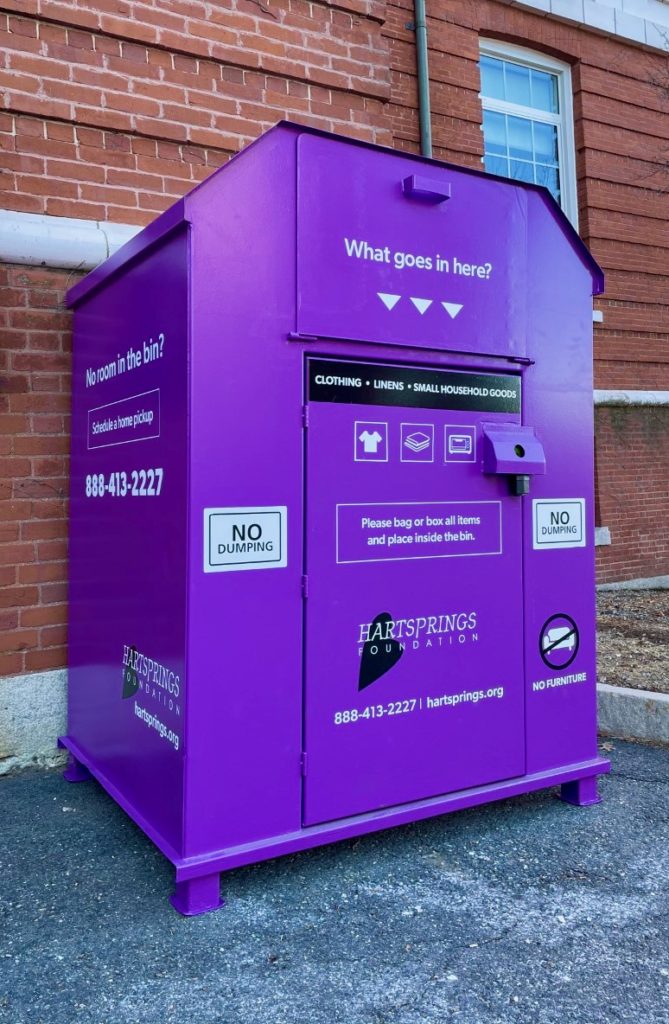 Metal purple collection bin behind Alumni